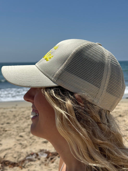 Side view of Sunshine Hat. Embroidered text on organic cotton and recycled polyester hat
