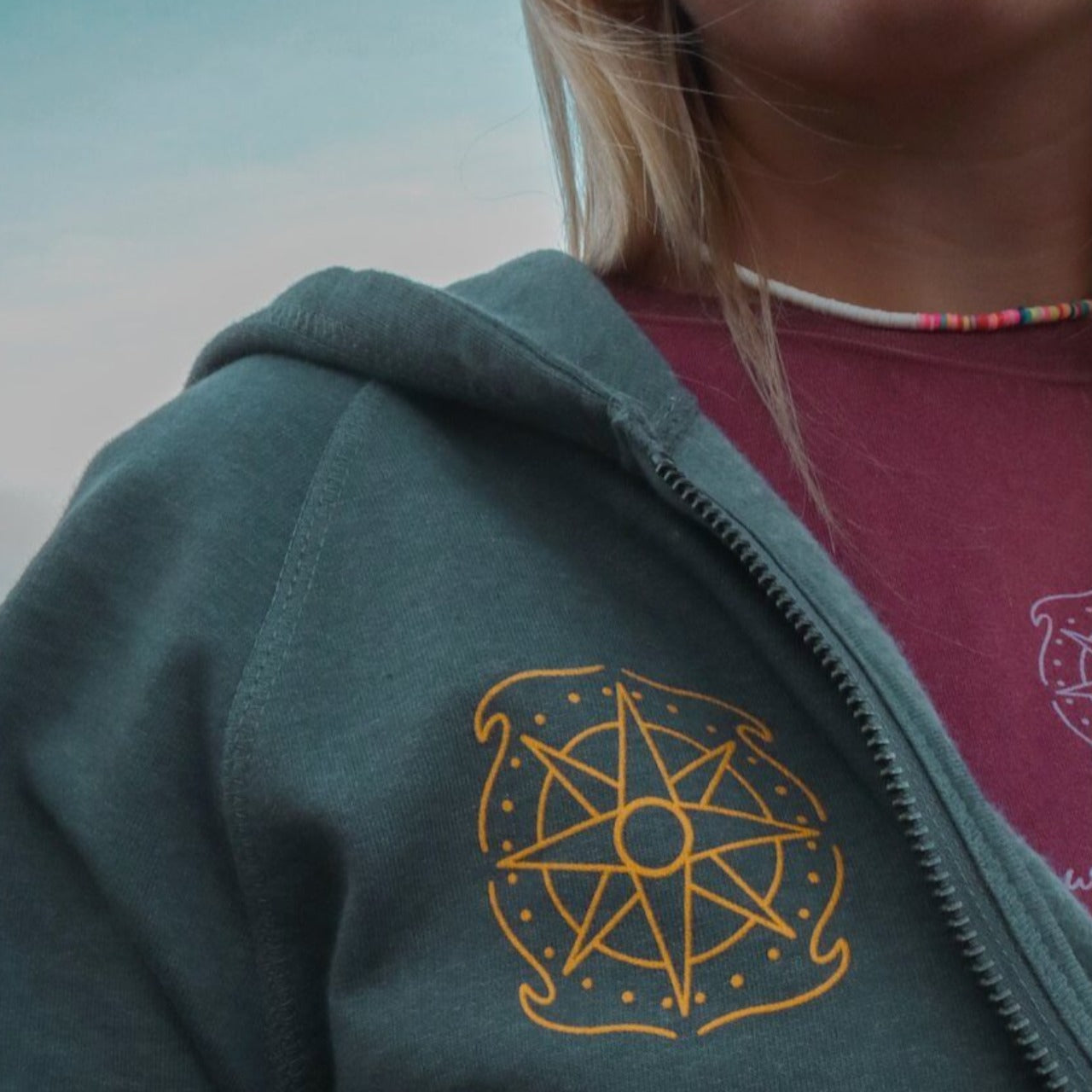 Wandering Waves Surf Company compass logo on front of "Chase The Sun" zip up hoodie